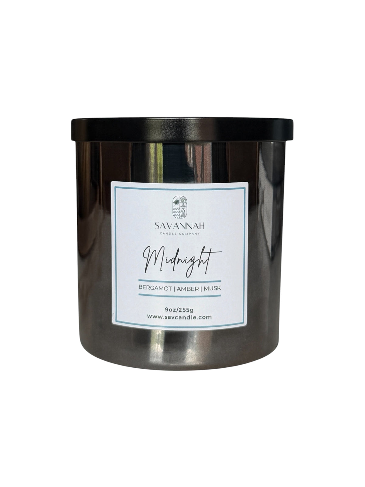 A Savannah Candle Co. jar candle in a dark metallic container with a black lid and a white label reading 'Midnight Bergamot | Amber | Musk'.