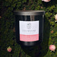 Savannah Candle Company candle with pink label on a green background with pink roses.  Rose fragrance. 