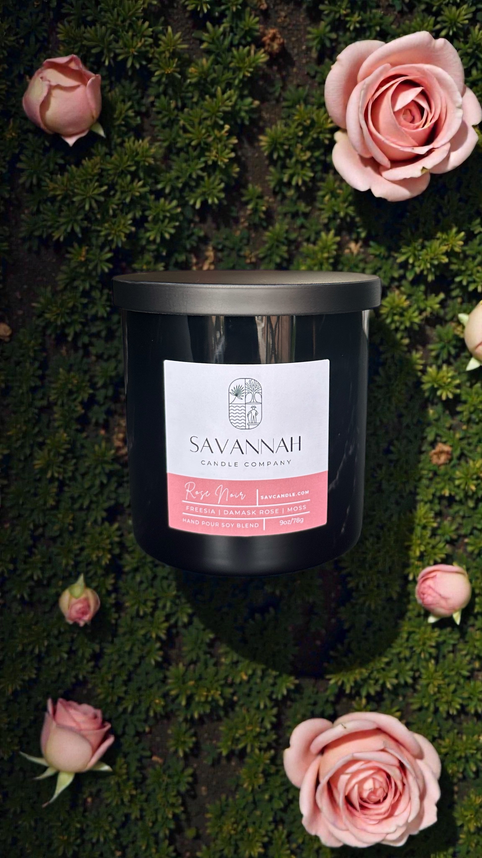 Savannah Candle Company candle with pink label on a green background with pink roses.  Rose fragrance. 