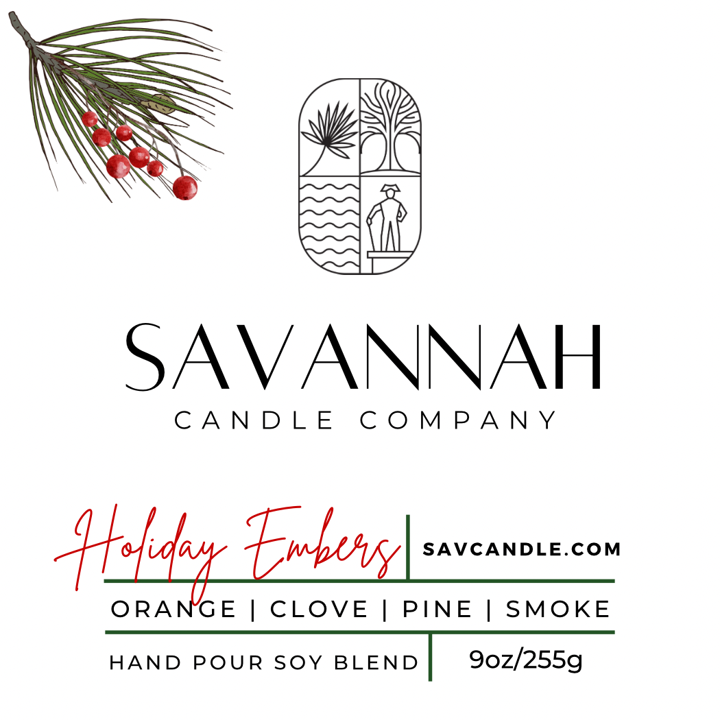 A clean white product label card for Savannah Candle Company, featuring a pine branch with red berries in the top left, the Savannah Candle Company logo in the center, and product details for 'Holiday Embers' soy blend including scent notes (Orange | Clove | Pine | Smoke) and weight (9oz/255g).