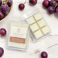 Savannah Candle Company wax melts with plums on a sandalwood surface