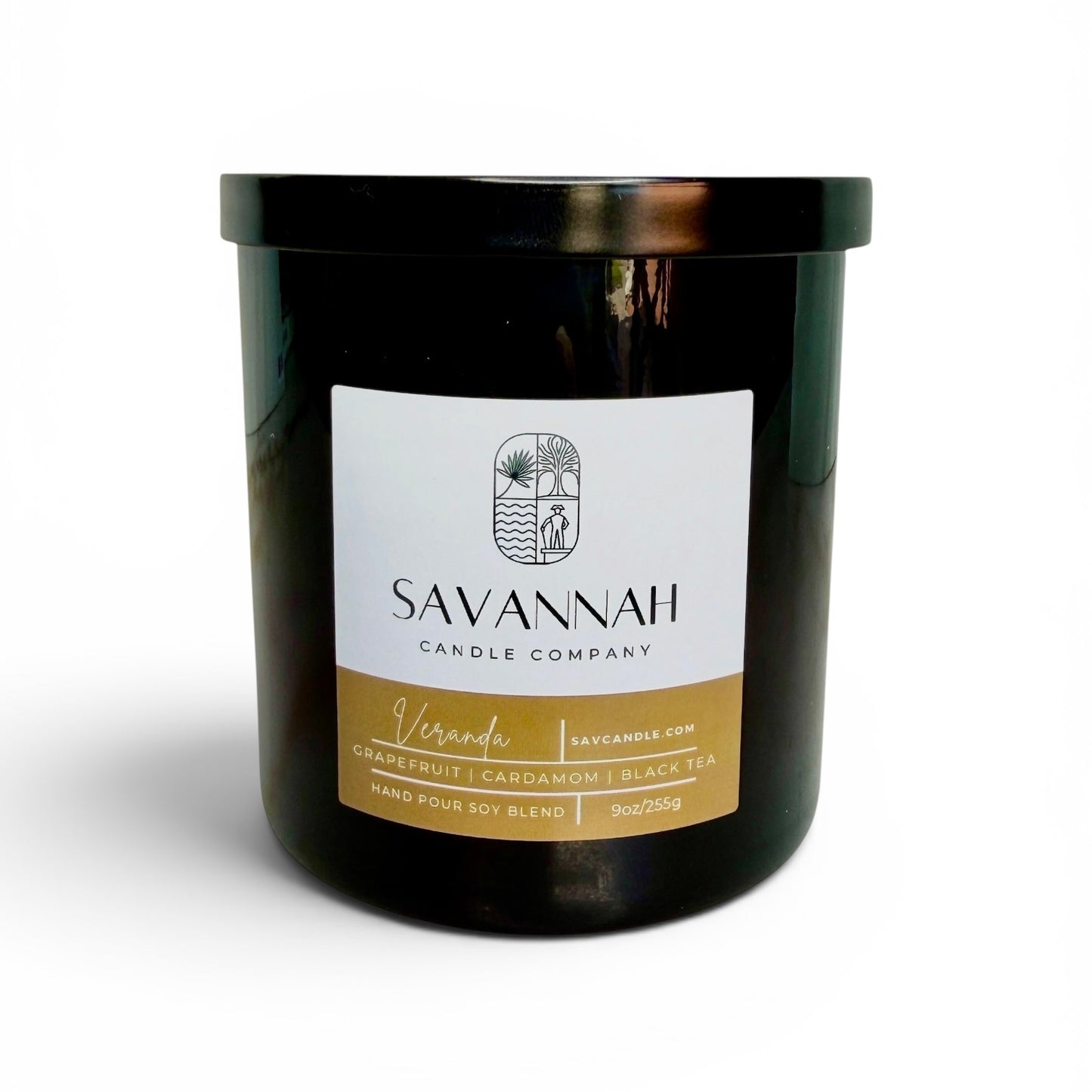 Black candle jar with a label from Savannah Candle Company on a white background.  Fragrance is cardamom, black tea, and grapefruit.  The candle’s name is veranda.