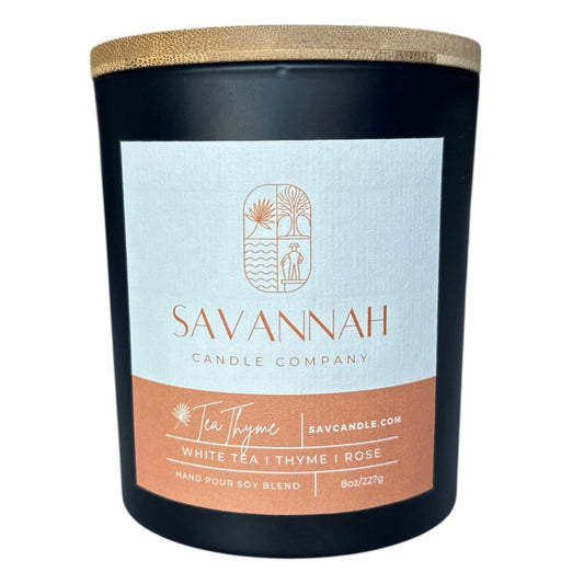 Savannah Candle Company candle with a label on a white background. This fragrance is white tea and thyme.  Notes of rose, lemon, white tea, and thyme.